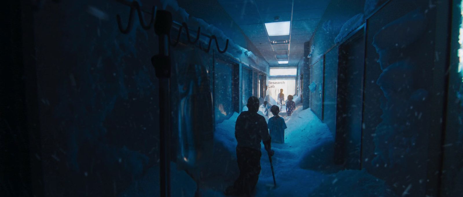 a group of people walking down a dark hallway