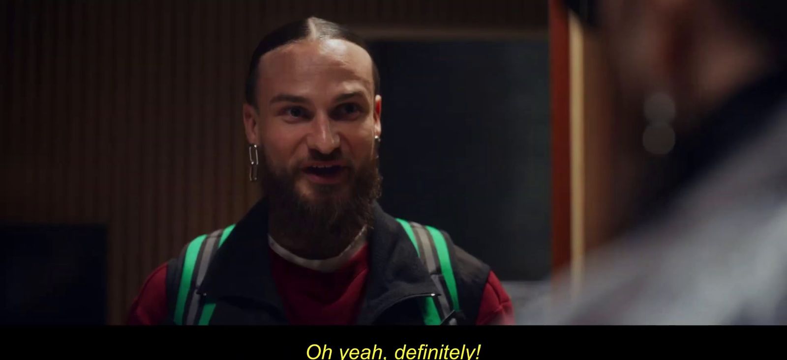 a man with a beard wearing a vest