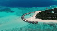 an aerial view of a resort in the middle of the ocean