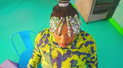 a woman wearing a colorful jacket and a headband