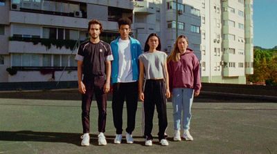 a group of people standing on top of a tennis court