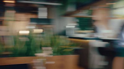 a blurry photo of a person sitting at a desk