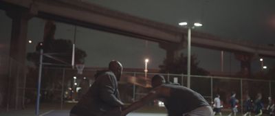 a couple of men standing on top of a tennis court