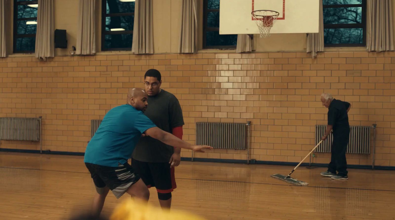 a group of men playing a game of basketball