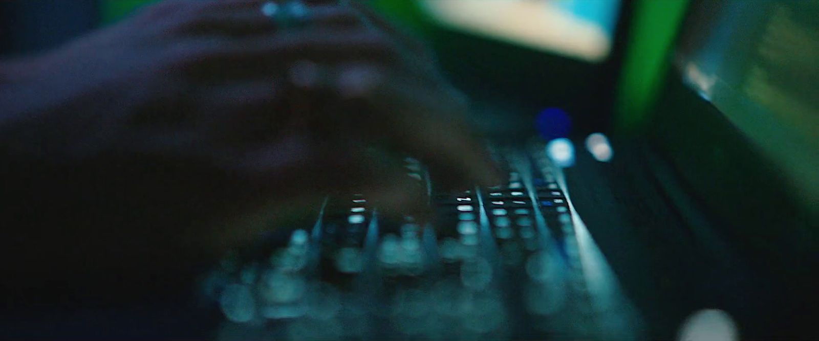 a close up of a person typing on a laptop