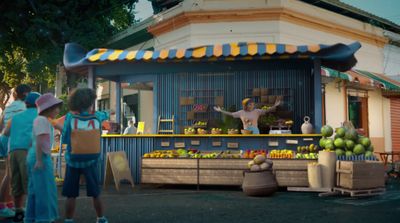 a group of people standing around a fruit stand