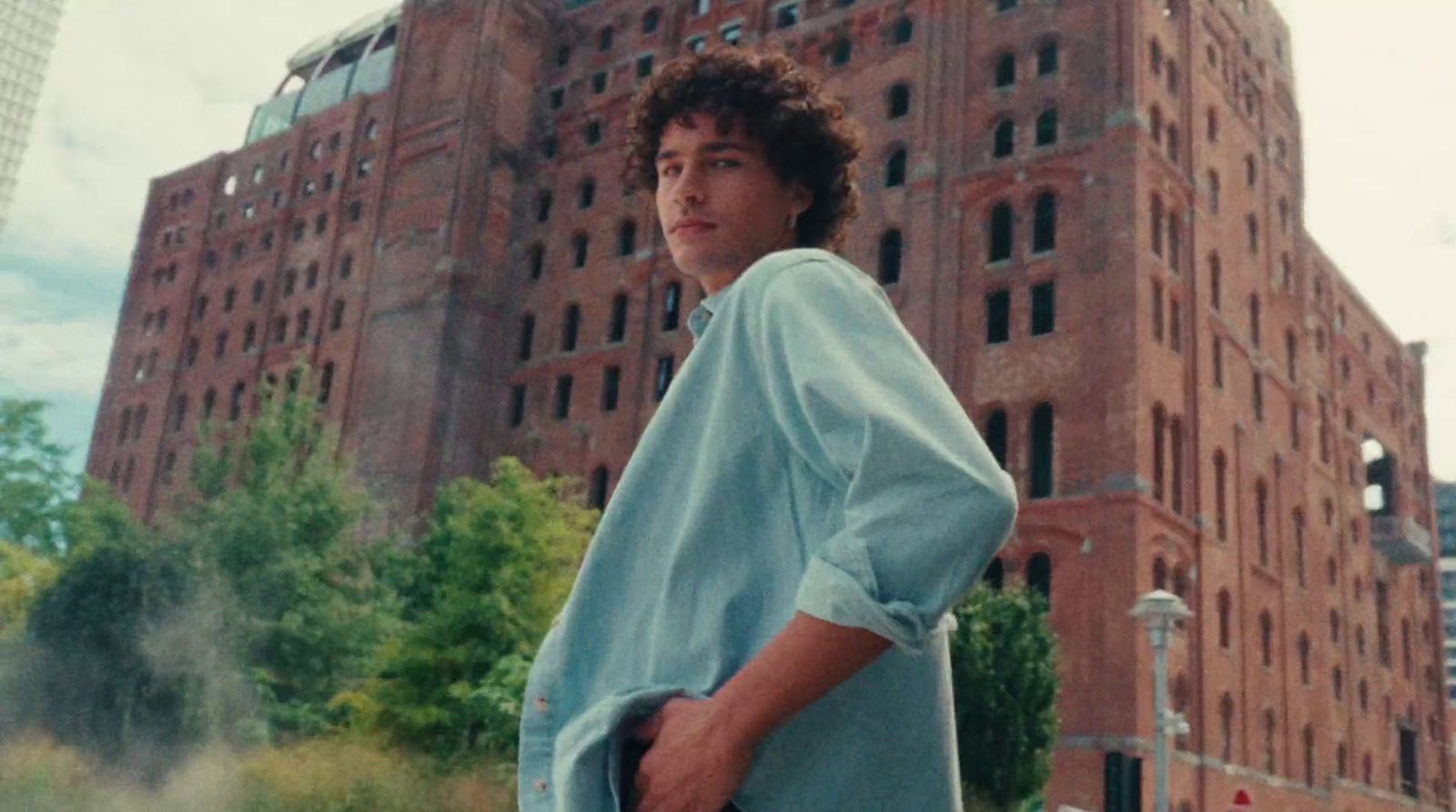 a man standing in front of a tall building