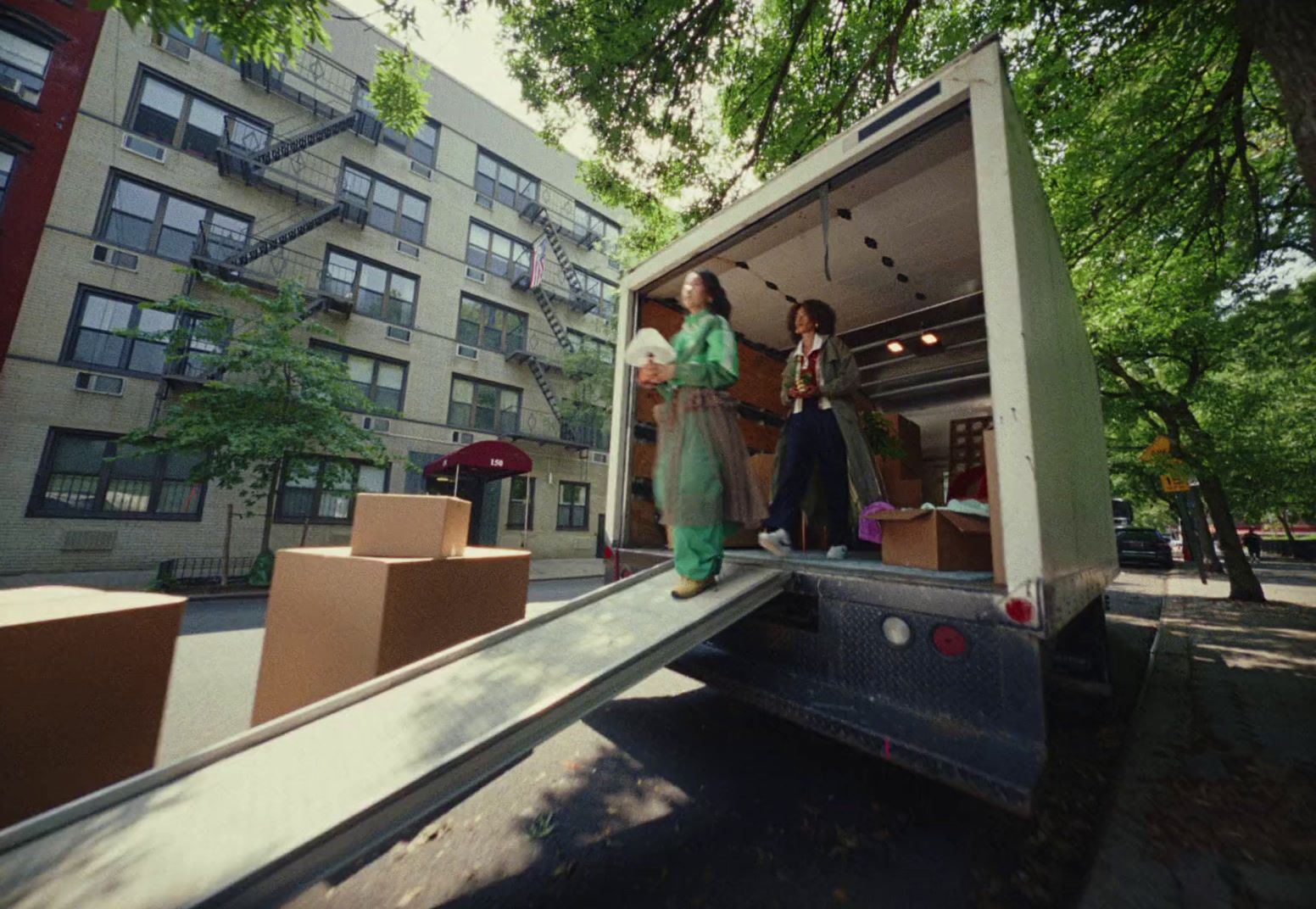 a couple of people that are standing in the back of a truck