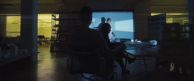 a group of people sitting around a table in a room