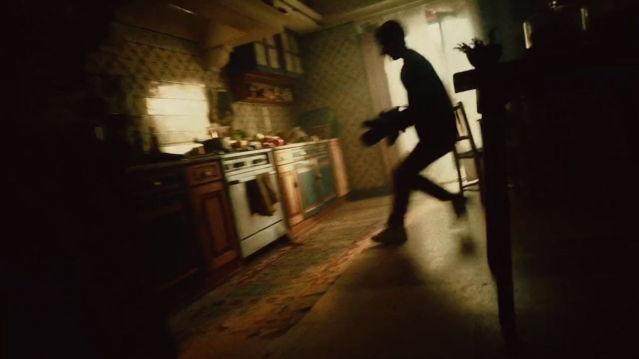 a blurry image of a person walking in a kitchen