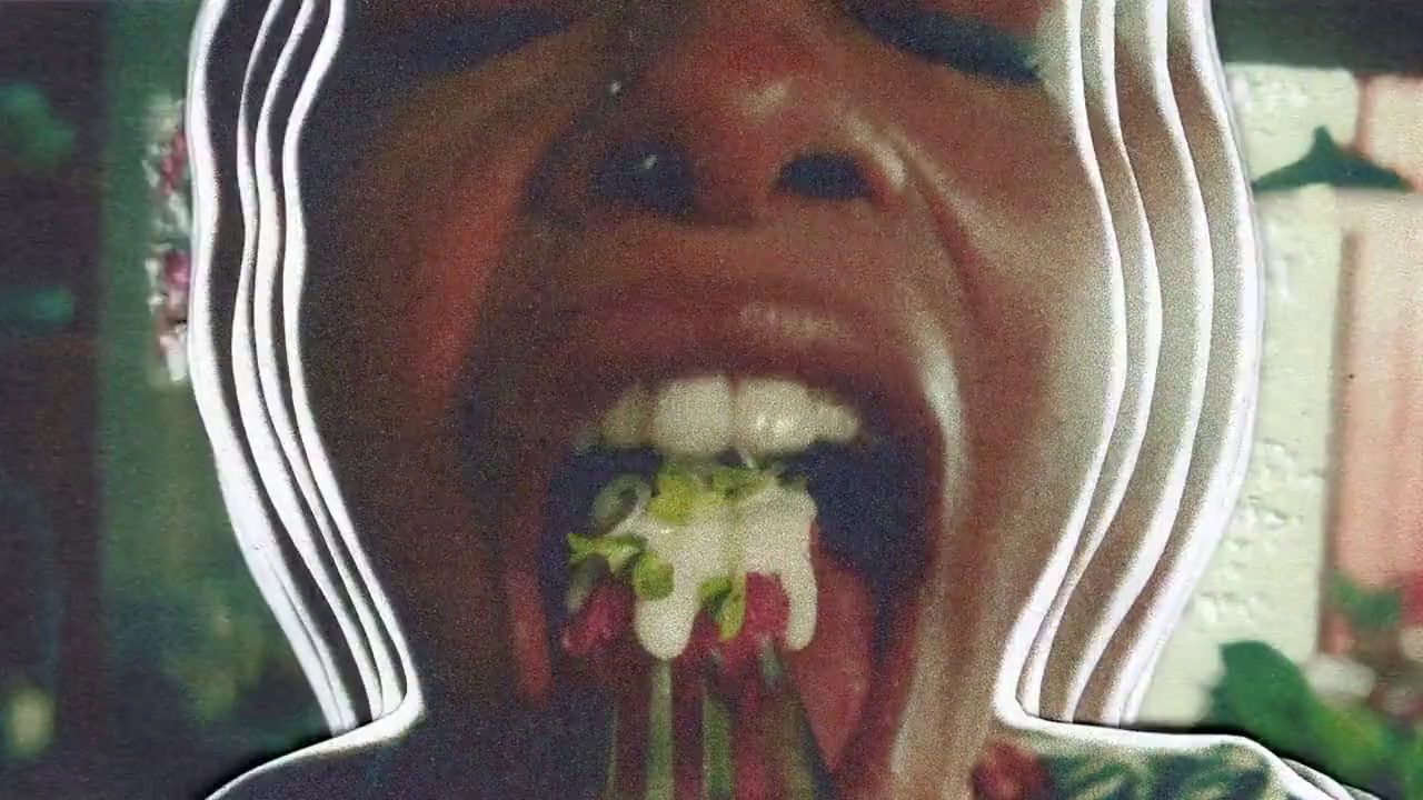 a woman eating a piece of food with a fork