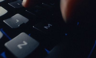 a close up of a person's hand on a computer keyboard