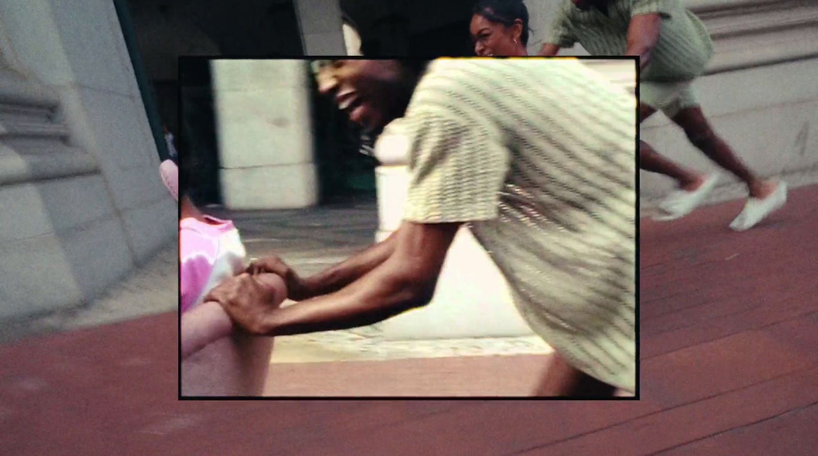 a man holding a woman's hand on a city street