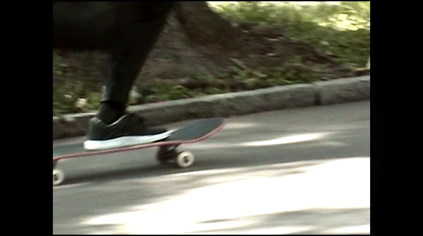 a person riding a skateboard down a street