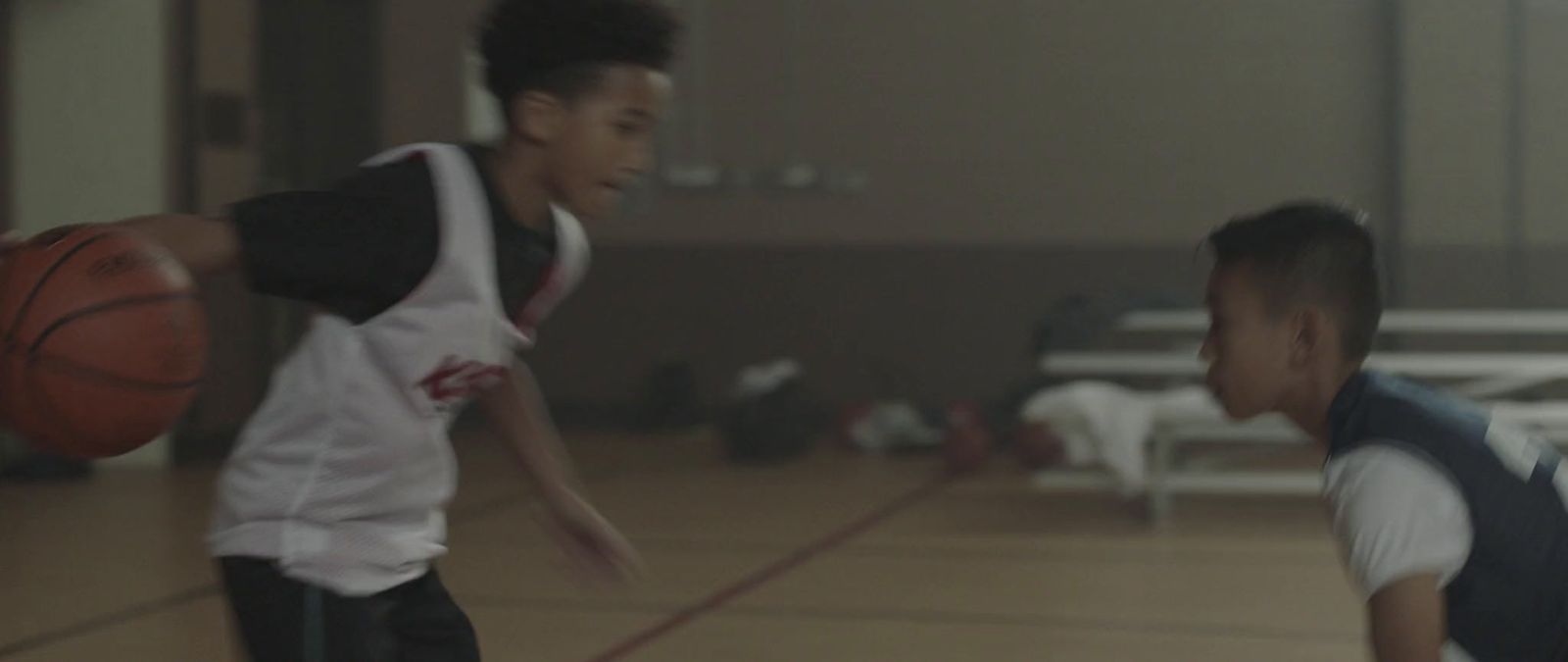 a couple of young men playing a game of basketball