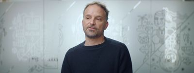 a man standing in front of a glass wall