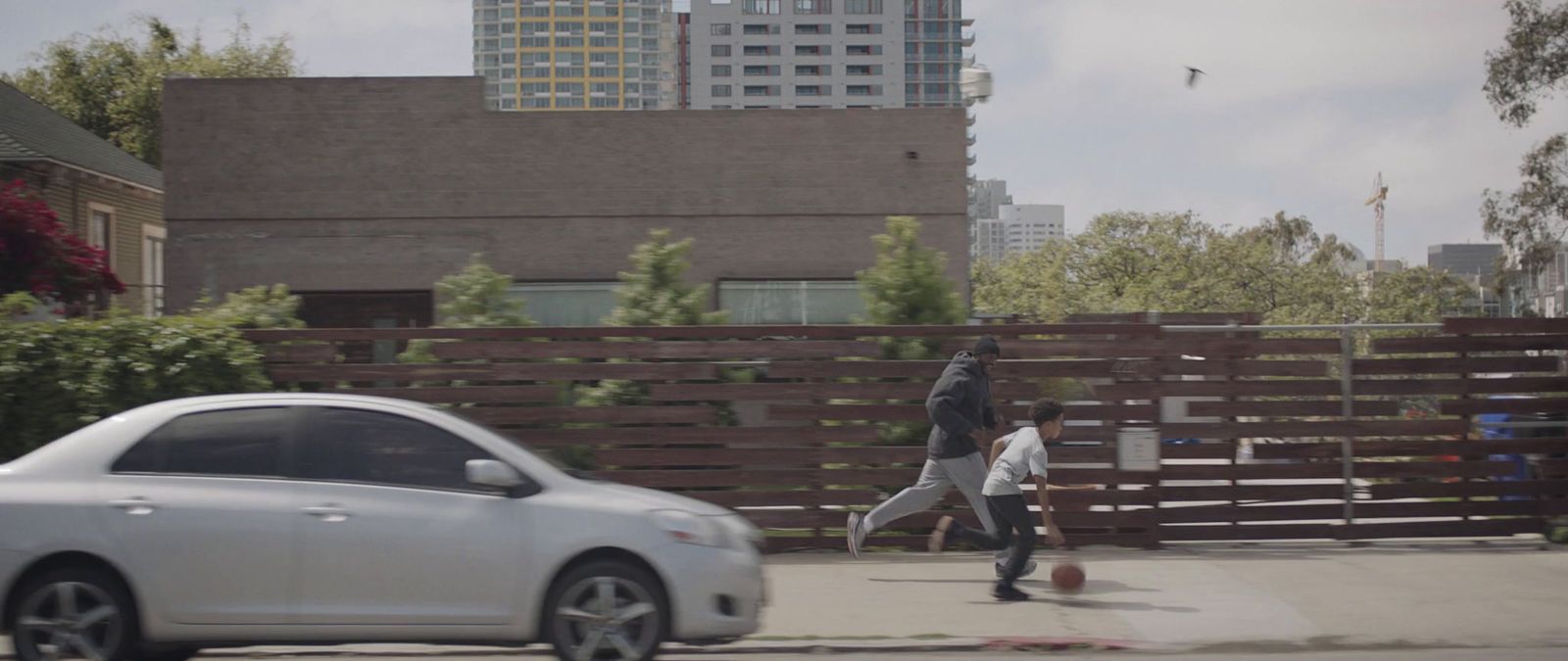 a couple of people walking across a street