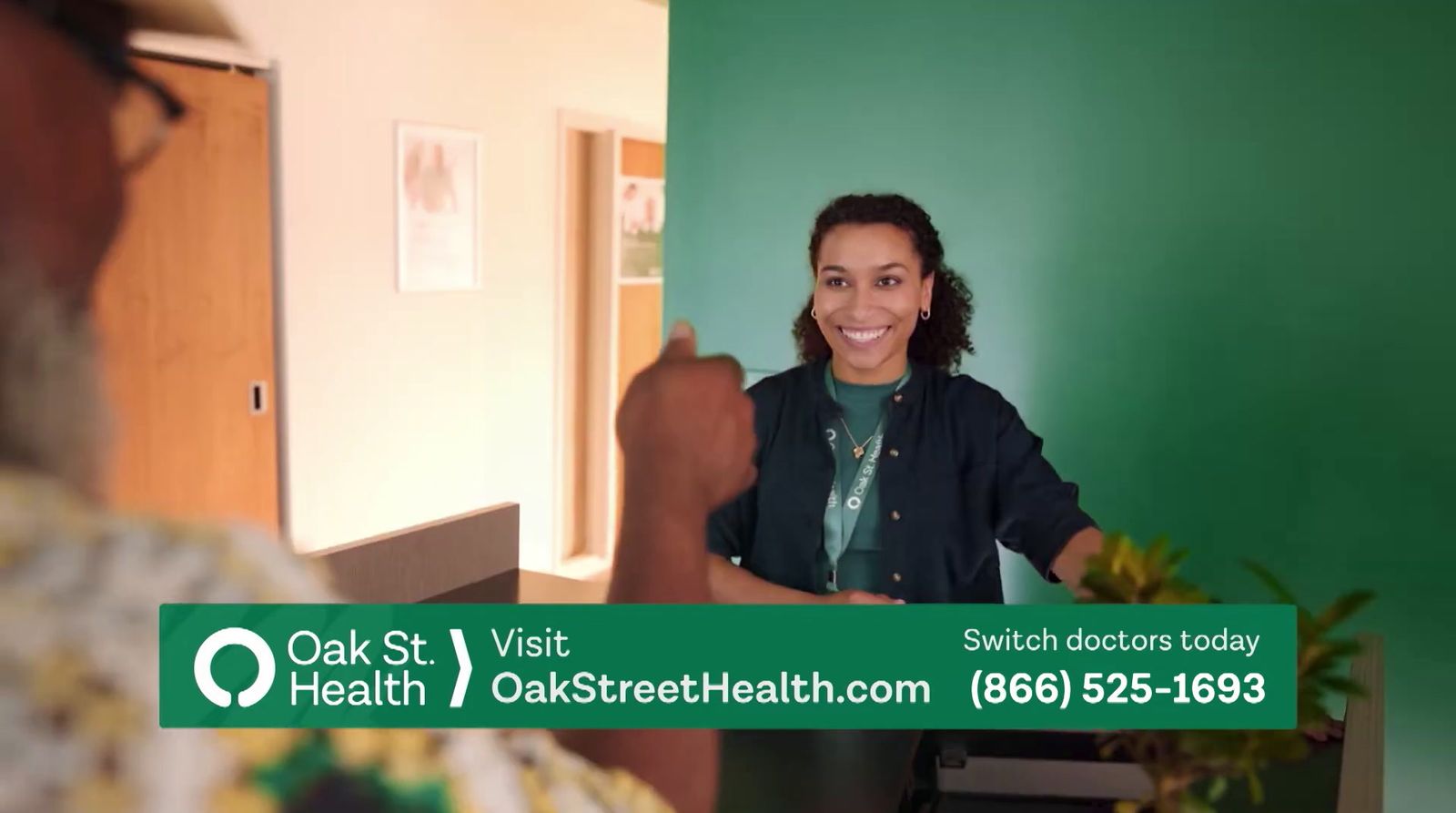 a woman standing in front of a green wall