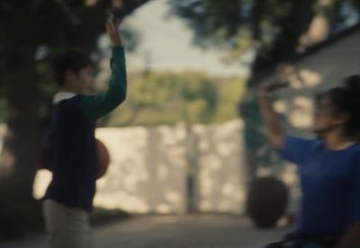 a man and a woman are playing with a frisbee