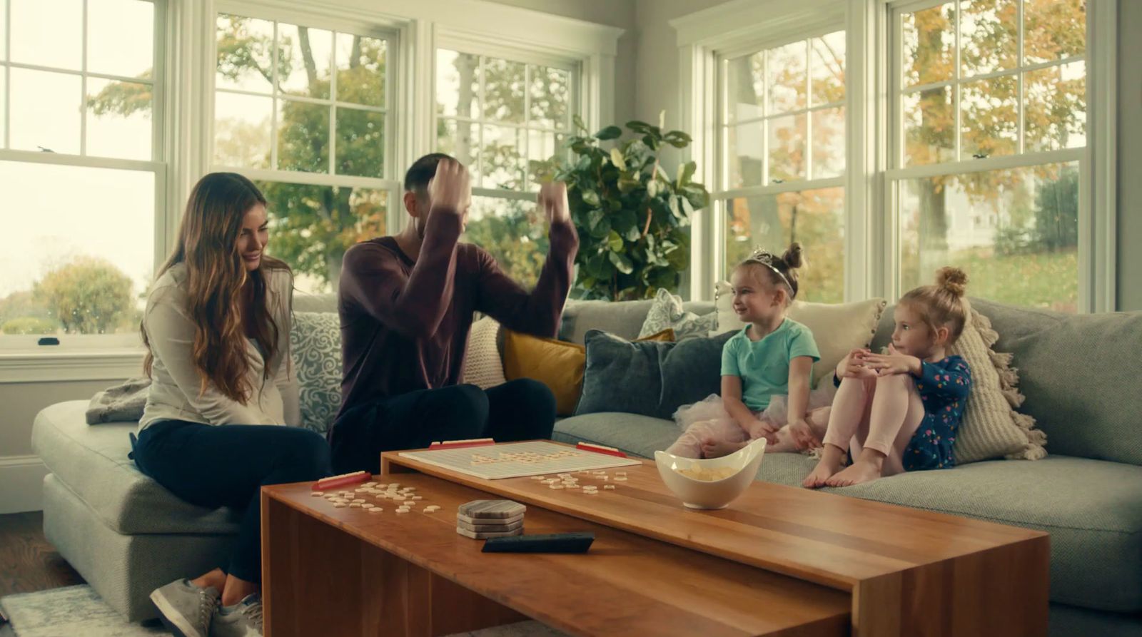 a family sitting on a couch in a living room