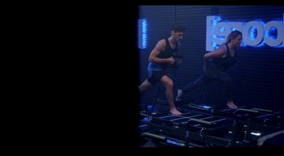 a man and a woman running on a treadmill