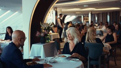 a man and woman sitting at a table in a restaurant