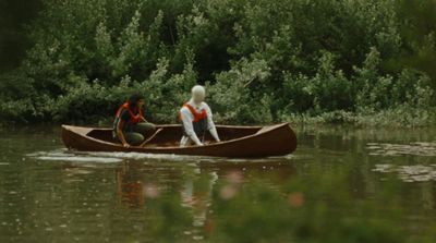 two people in a canoe on a body of water