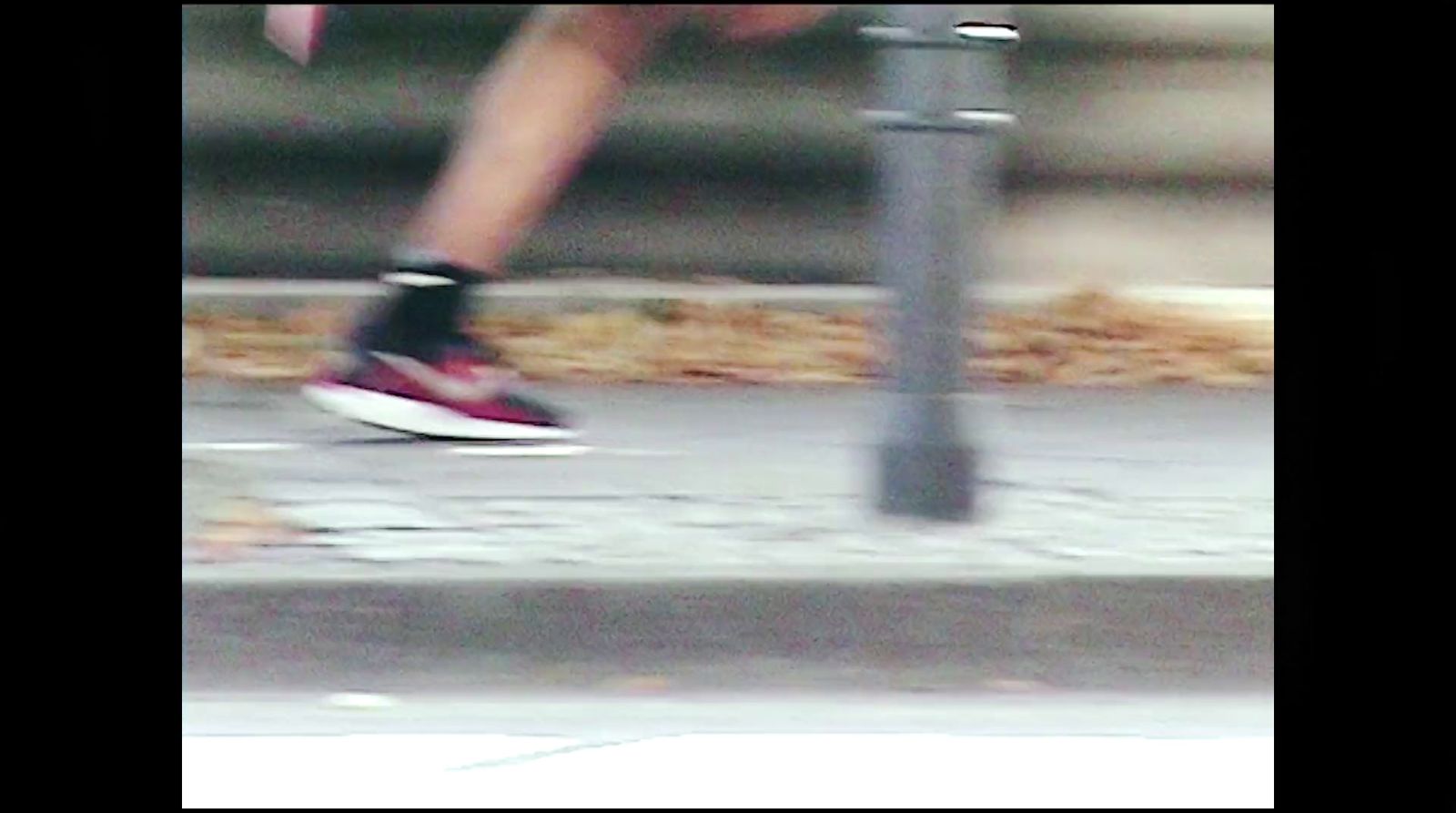 a blurry photo of a person running on a sidewalk