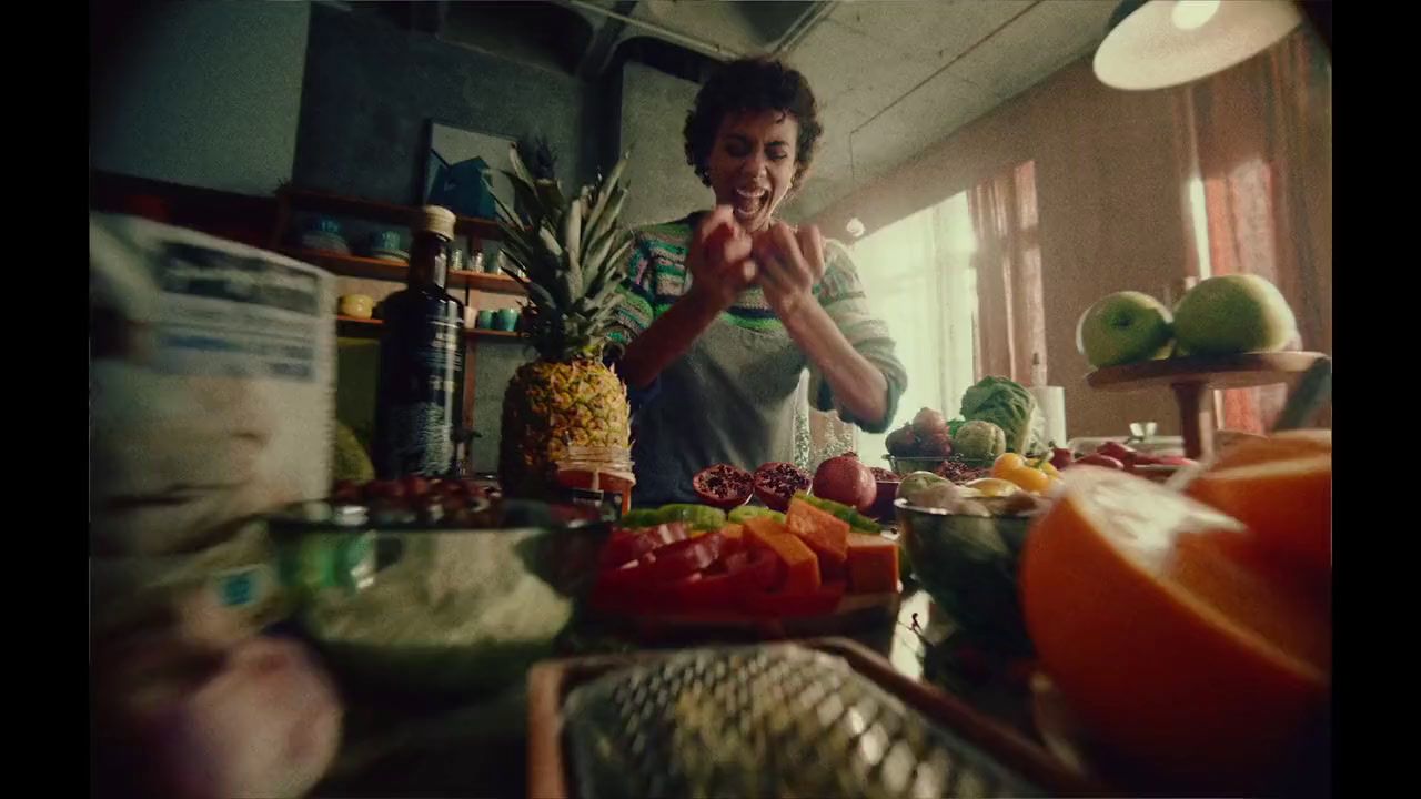 a man standing in front of a counter filled with fruits and vegetables