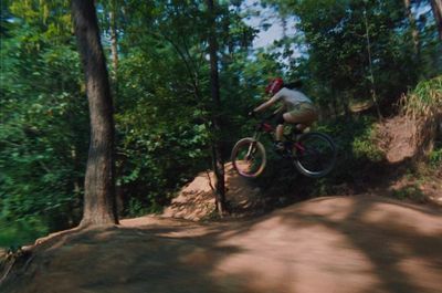 a man riding a bike down a dirt road