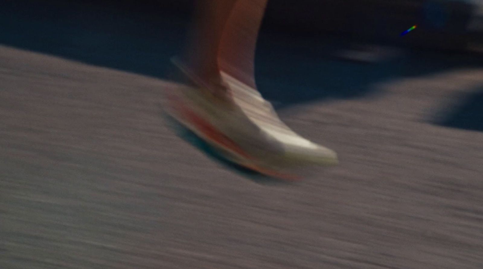 a close up of a person walking on a sidewalk