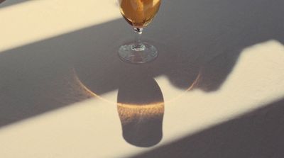 a glass of wine sitting on top of a table