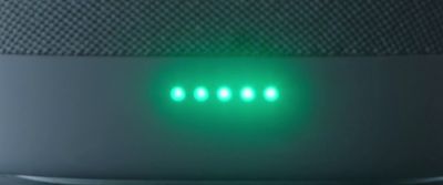 a close up of a green light on a speaker