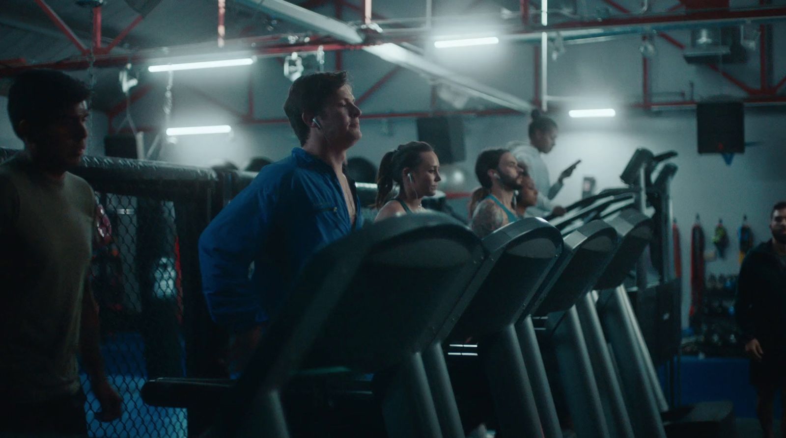 a group of people standing around a gym