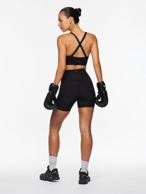 a woman in a black sports bra top and shorts