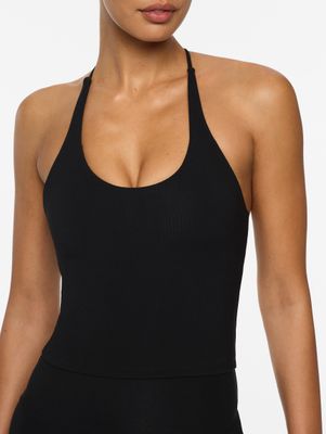 a woman wearing a black one piece swimsuit