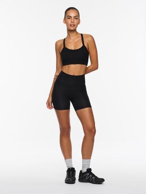 a woman in a black sports bra top and shorts