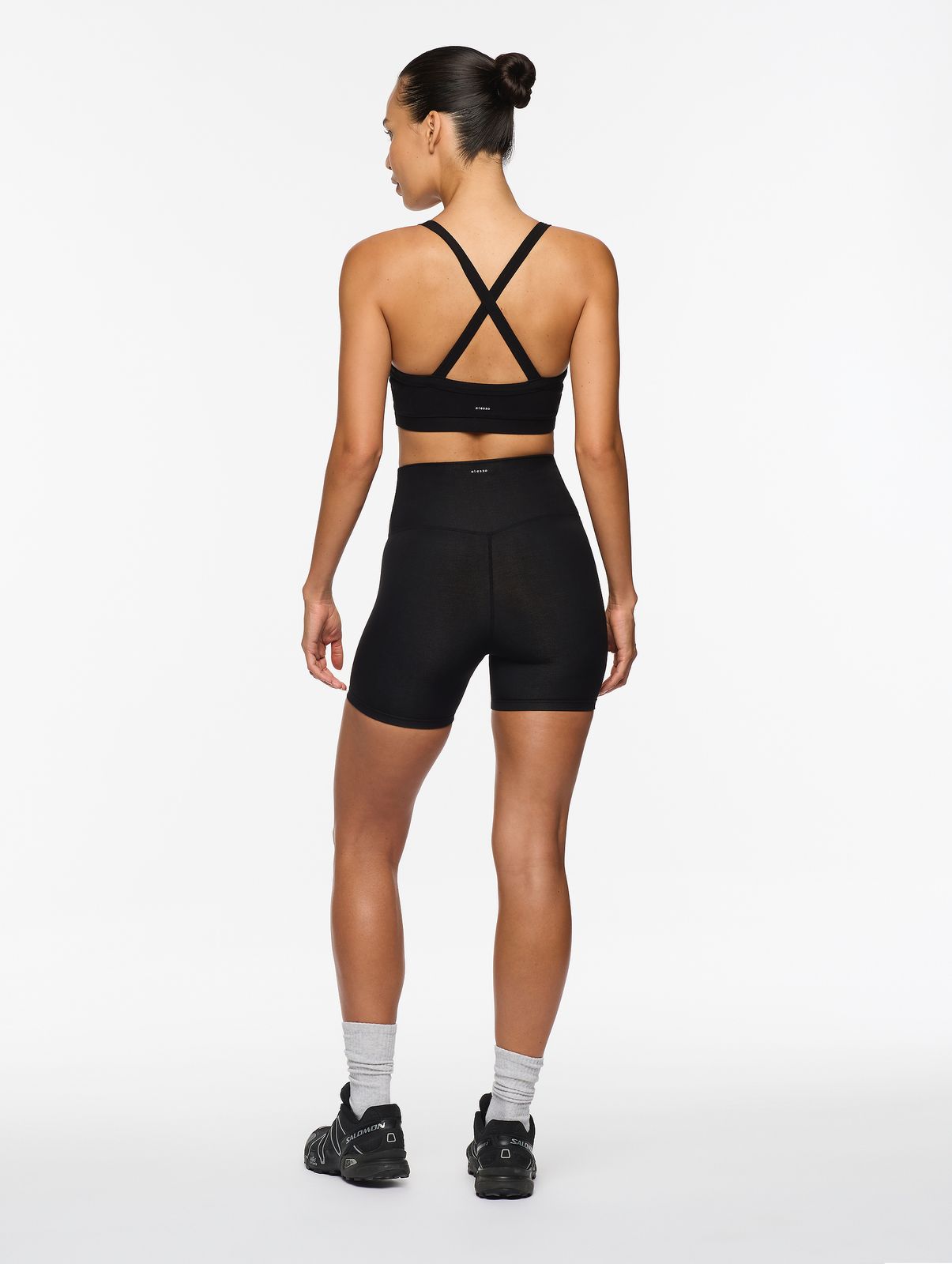 a woman in a black sports bra top and shorts