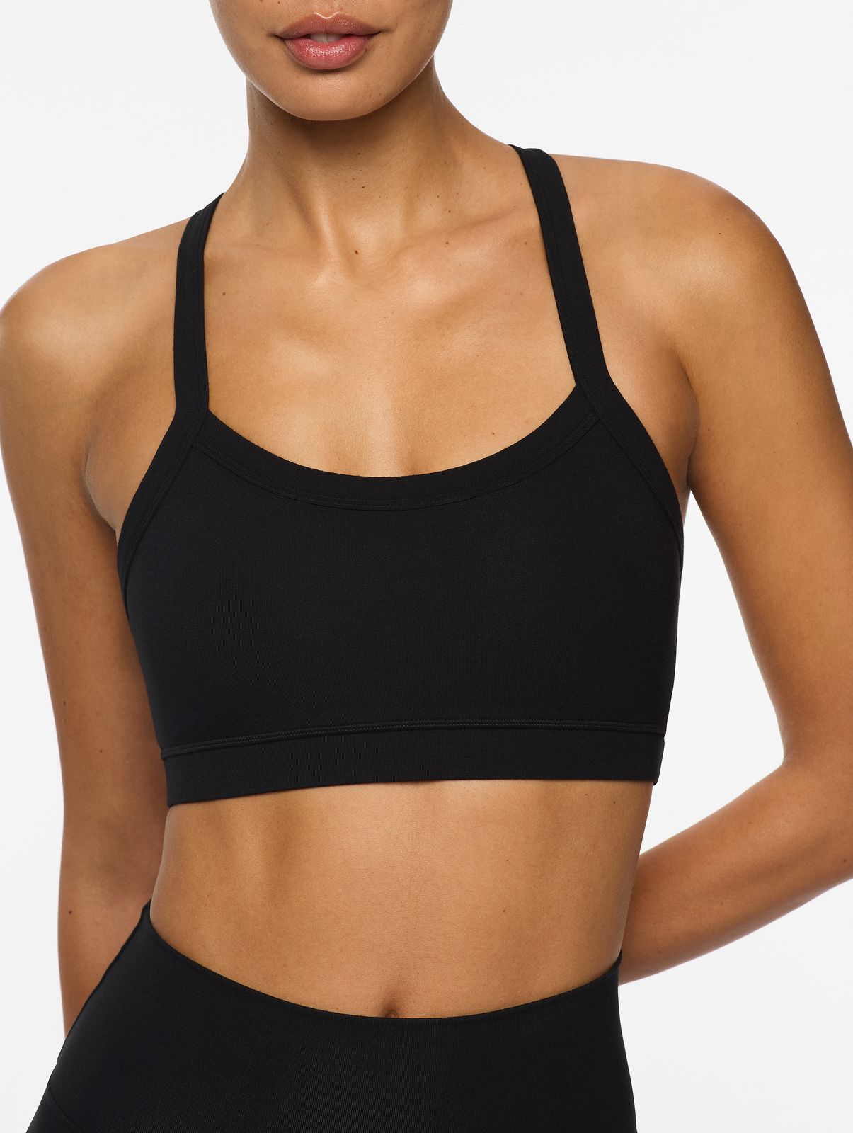 a woman wearing a black sports bra top