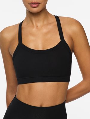 a woman wearing a black sports bra top