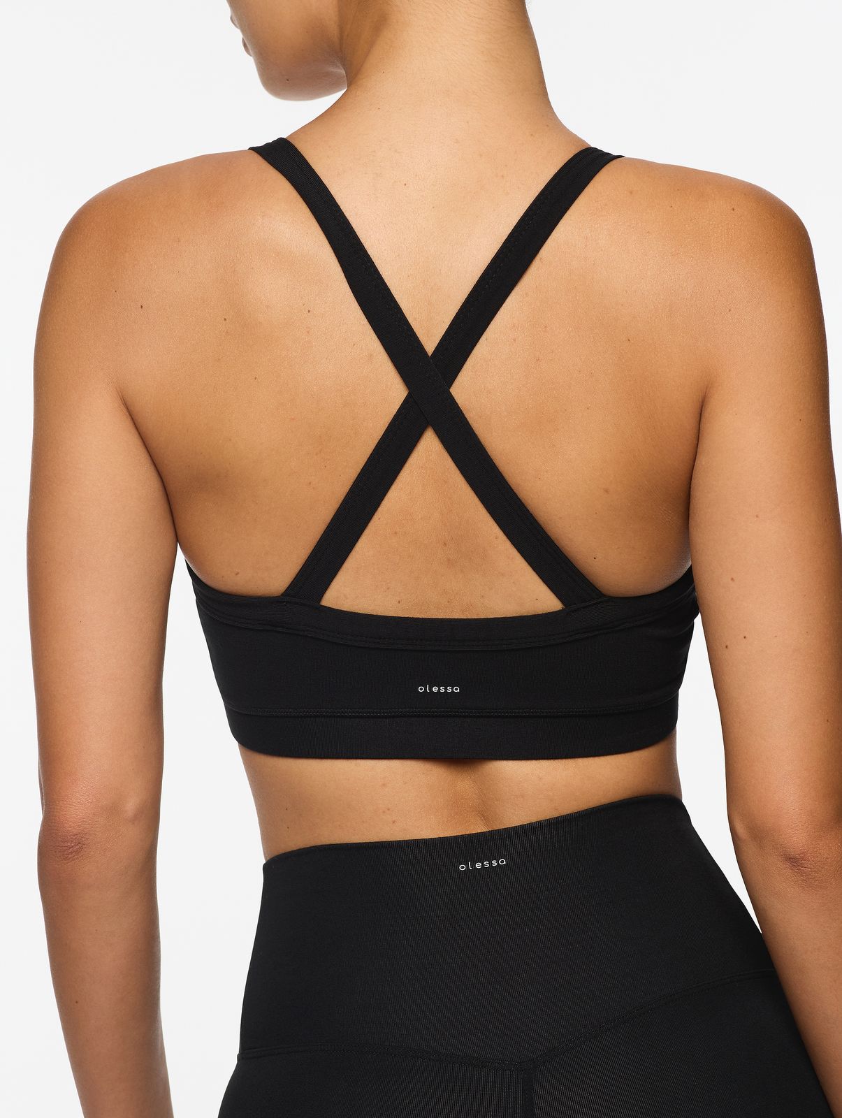 the back of a woman wearing a black sports bra
