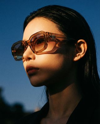 a woman wearing a pair of brown sunglasses
