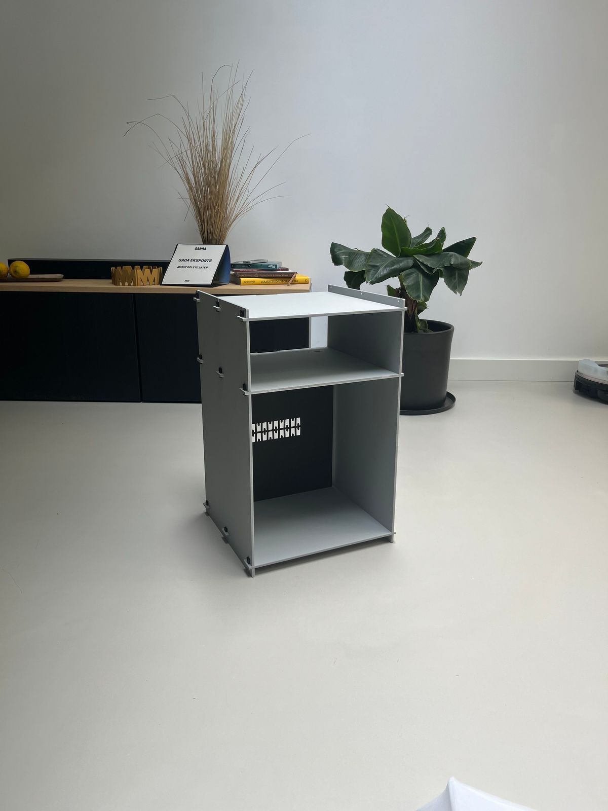 a desk with a plant on top of it