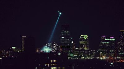 a view of a city at night with a light show