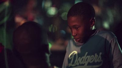 a young boy looking at his cell phone