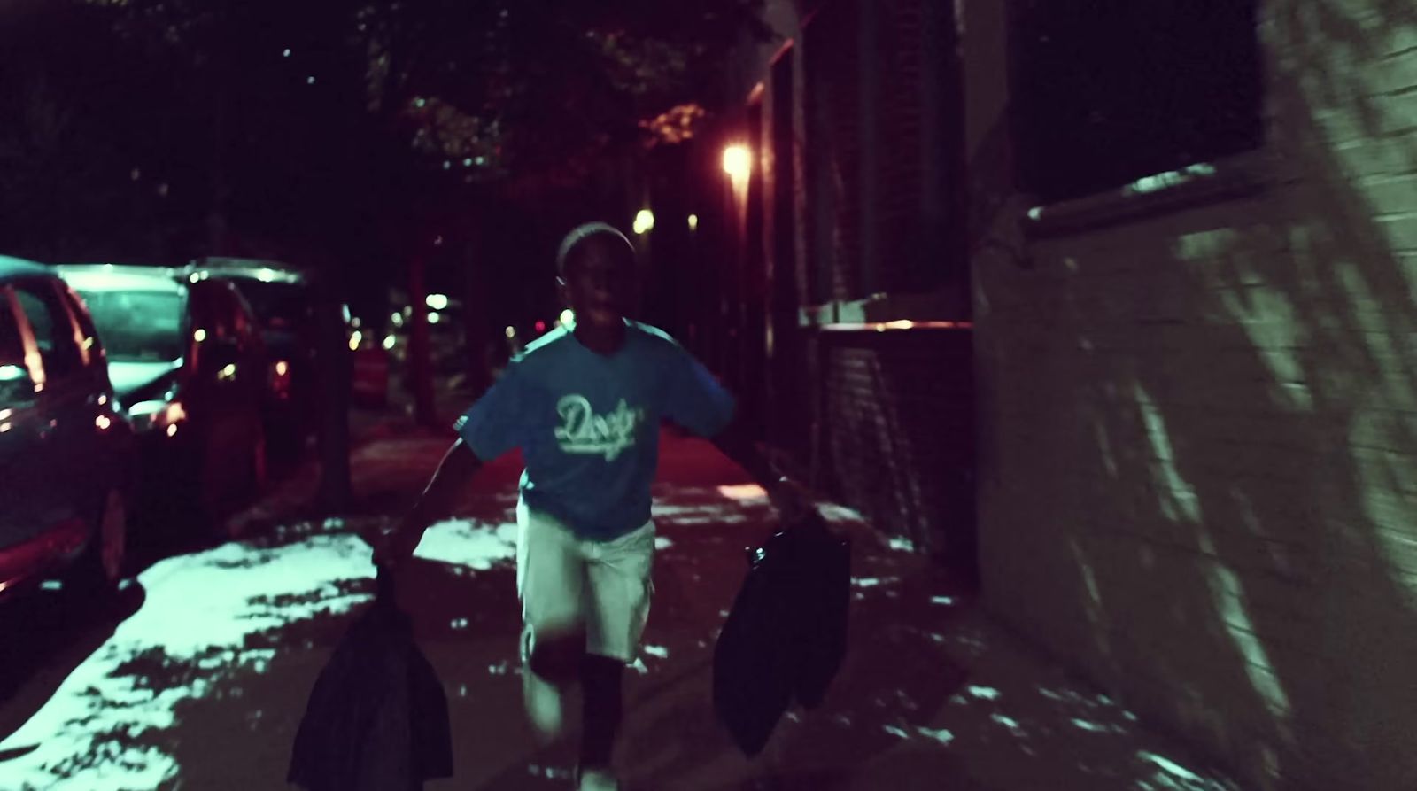 a man walking down a street at night