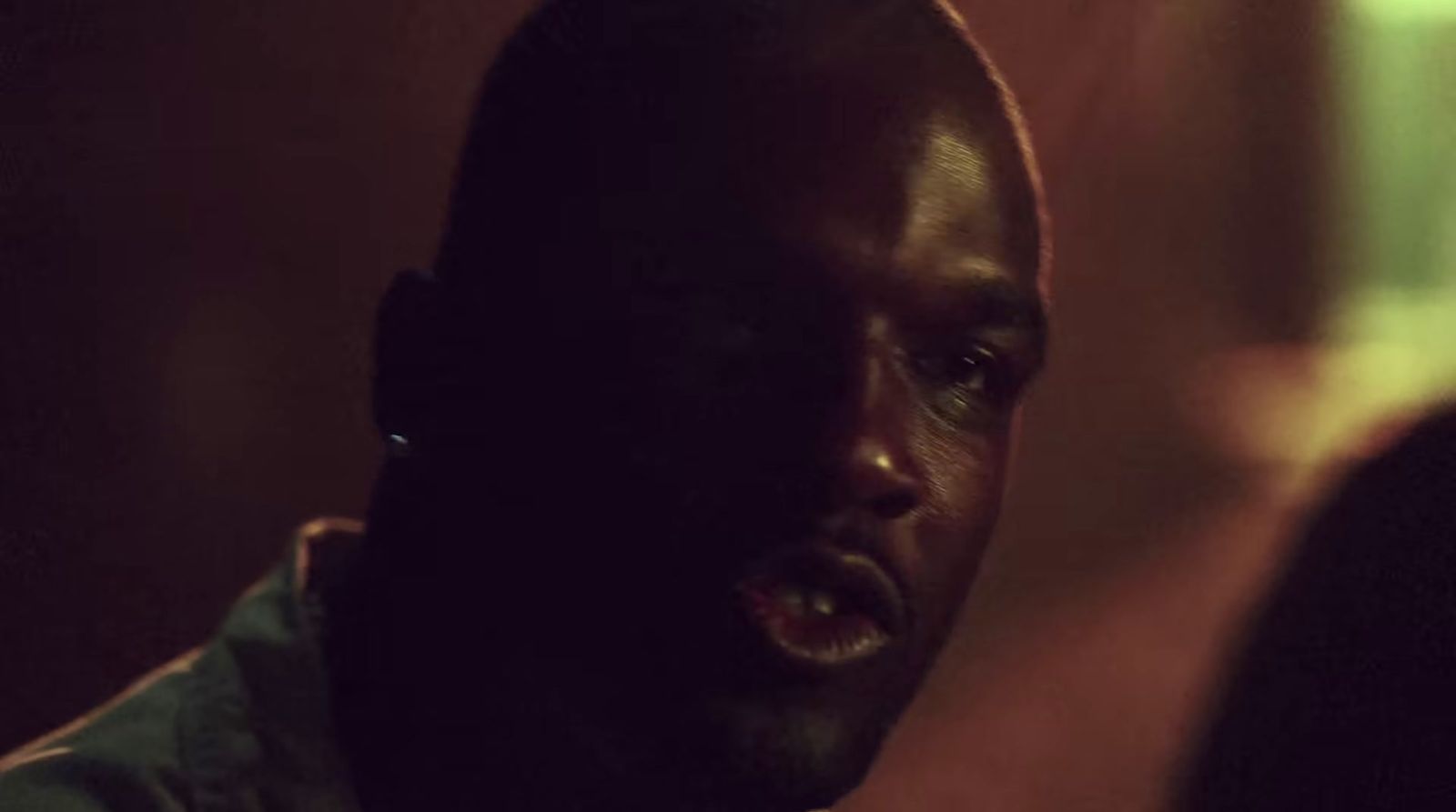 a man with his mouth open in a dark room