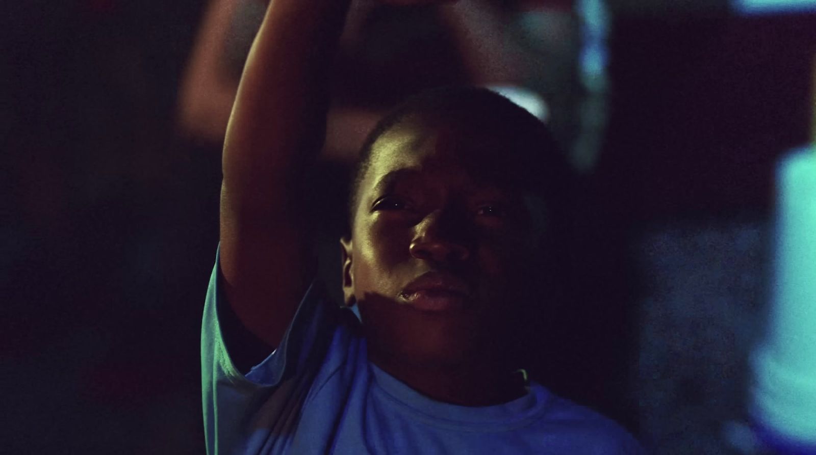 a woman holding a cell phone up in the air