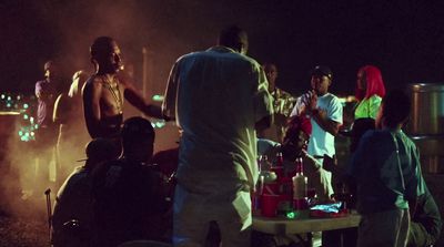 a group of people standing around a table