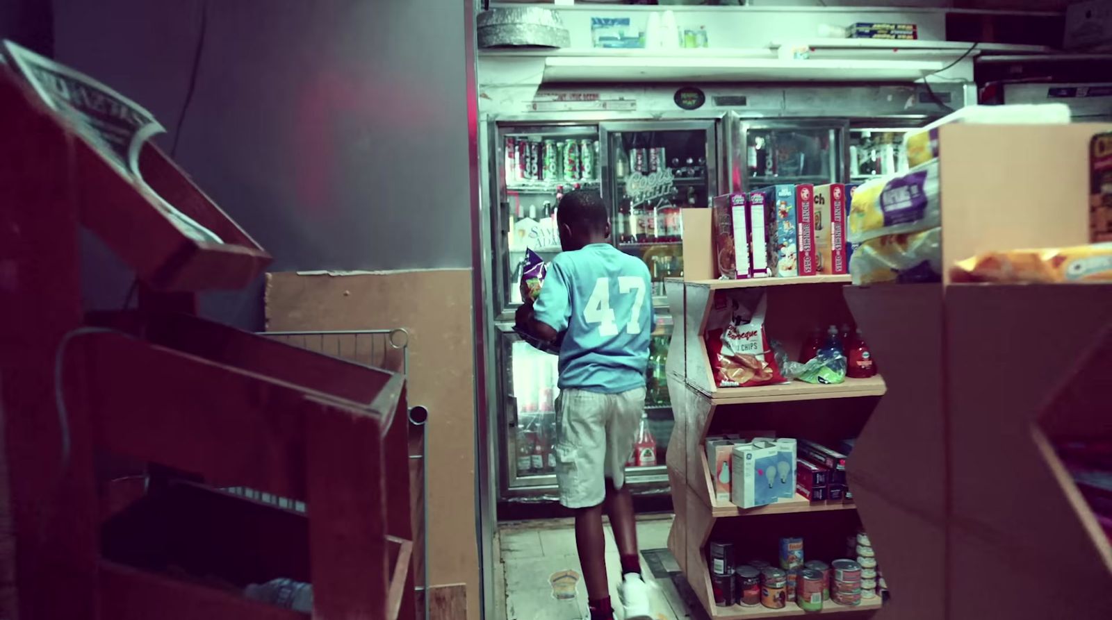 a man standing in front of a refrigerator filled with food